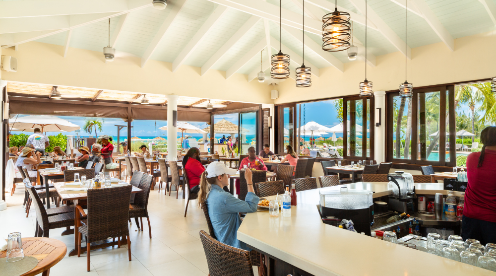 a group of people sitting at tables in a restaurant