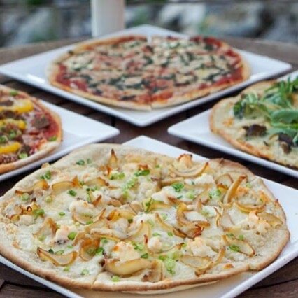a group of pizzas on a table