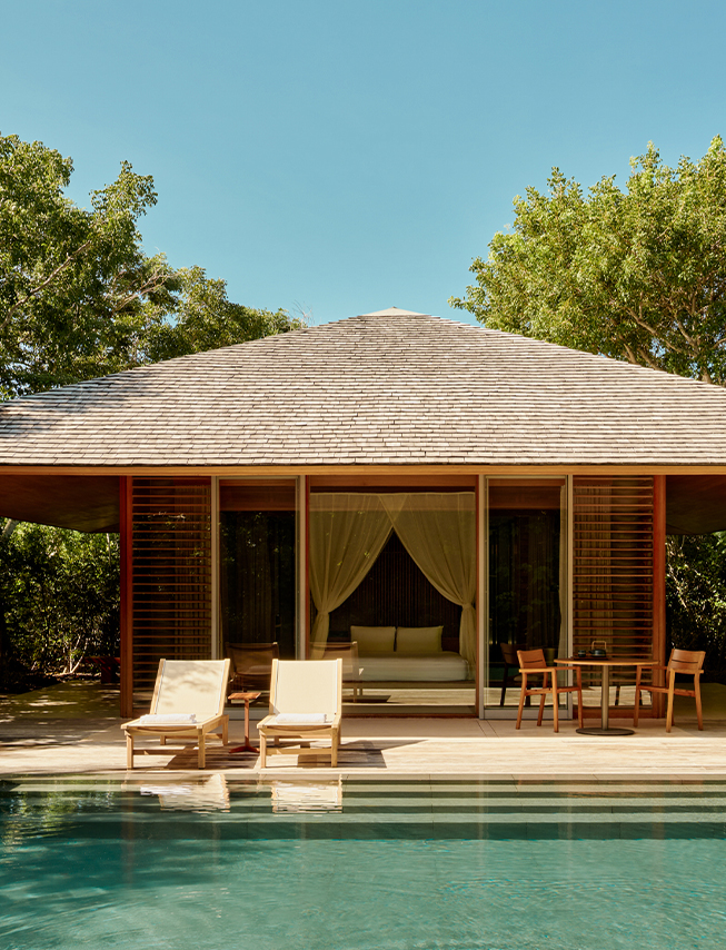 a small house with a pool and chairs