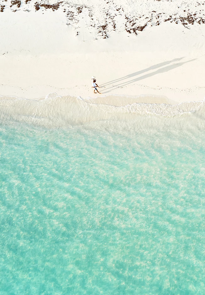 a person walking on a beach