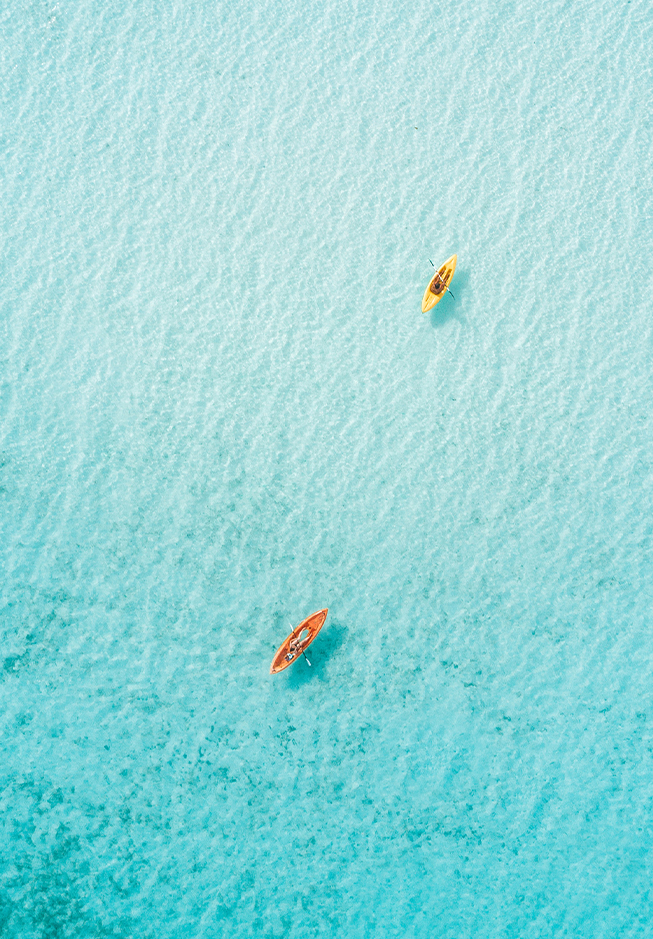 a couple of kayaks in clear blue water