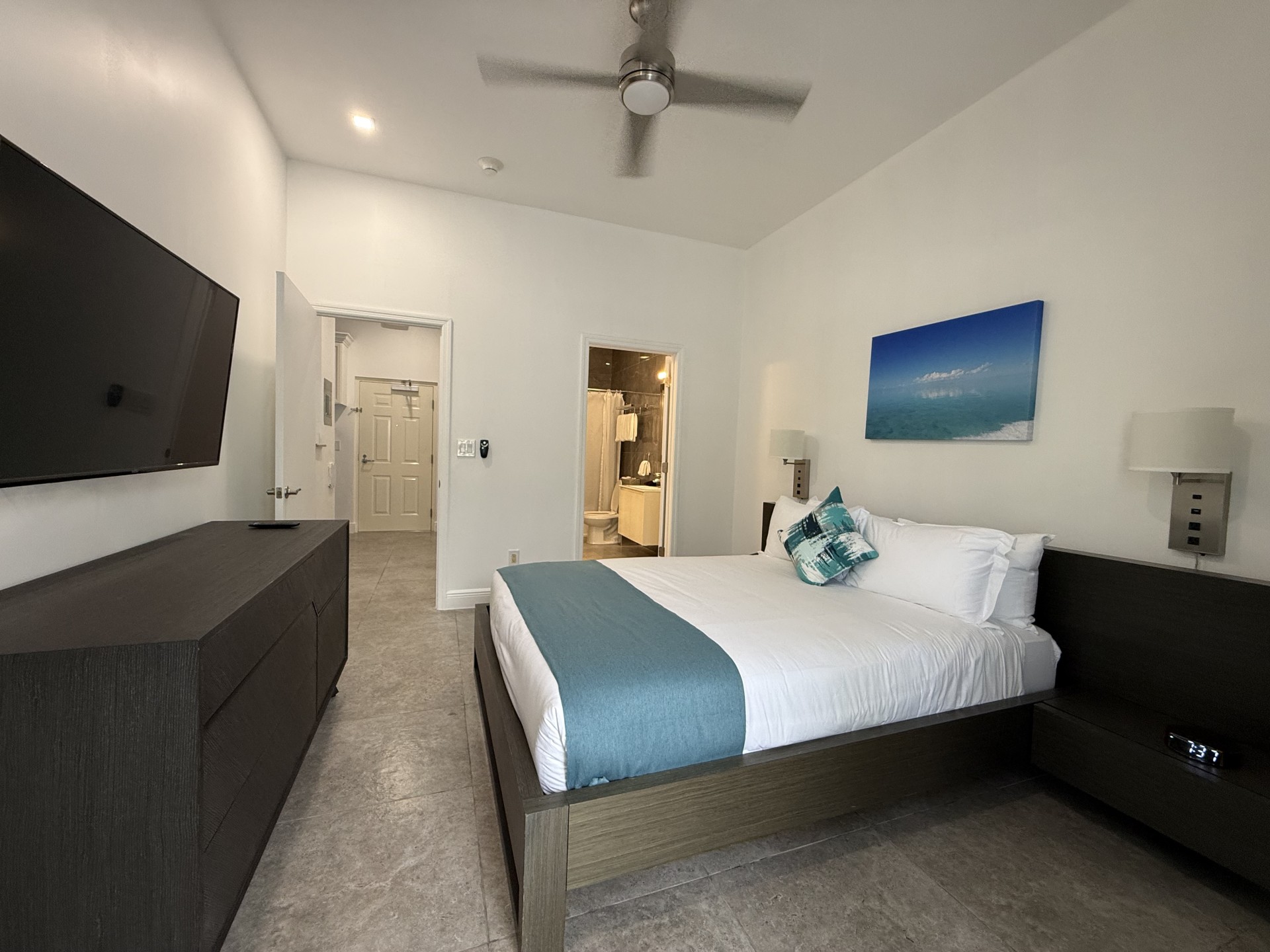 a bedroom with a bed and a television