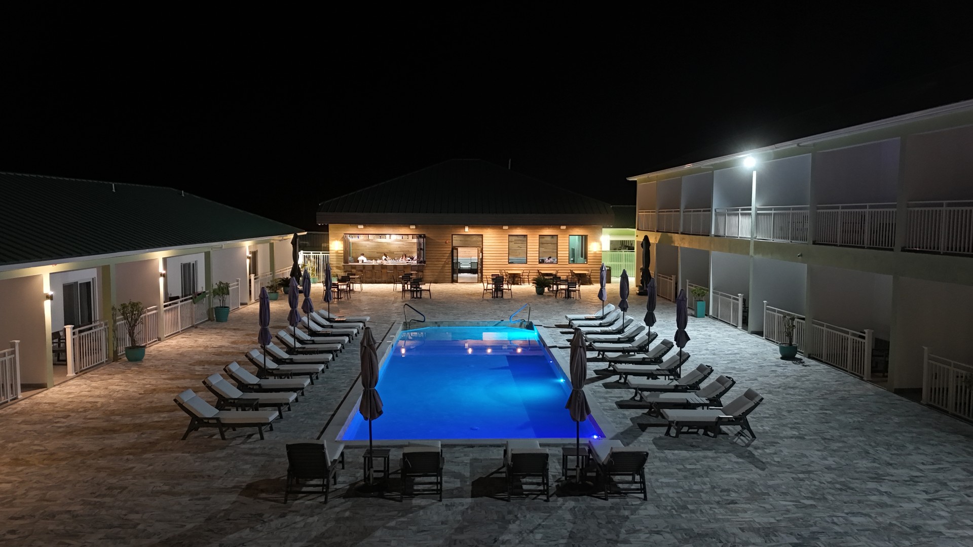 a pool with chairs and umbrellas in a pool