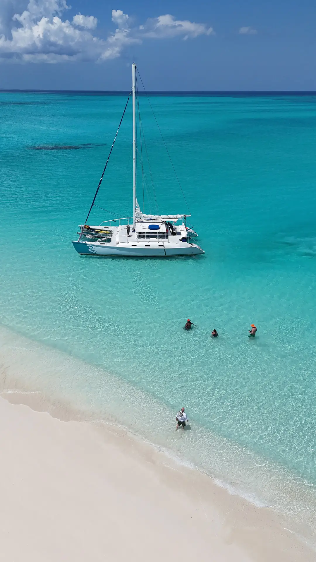 a group of people swimming in clear blue water