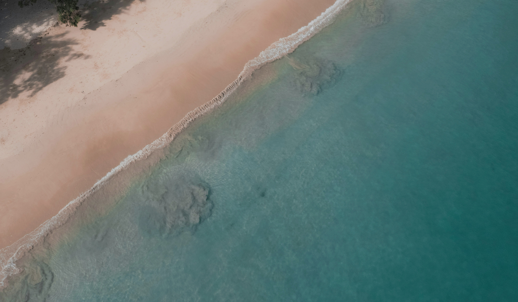 a beach with waves crashing on the shore