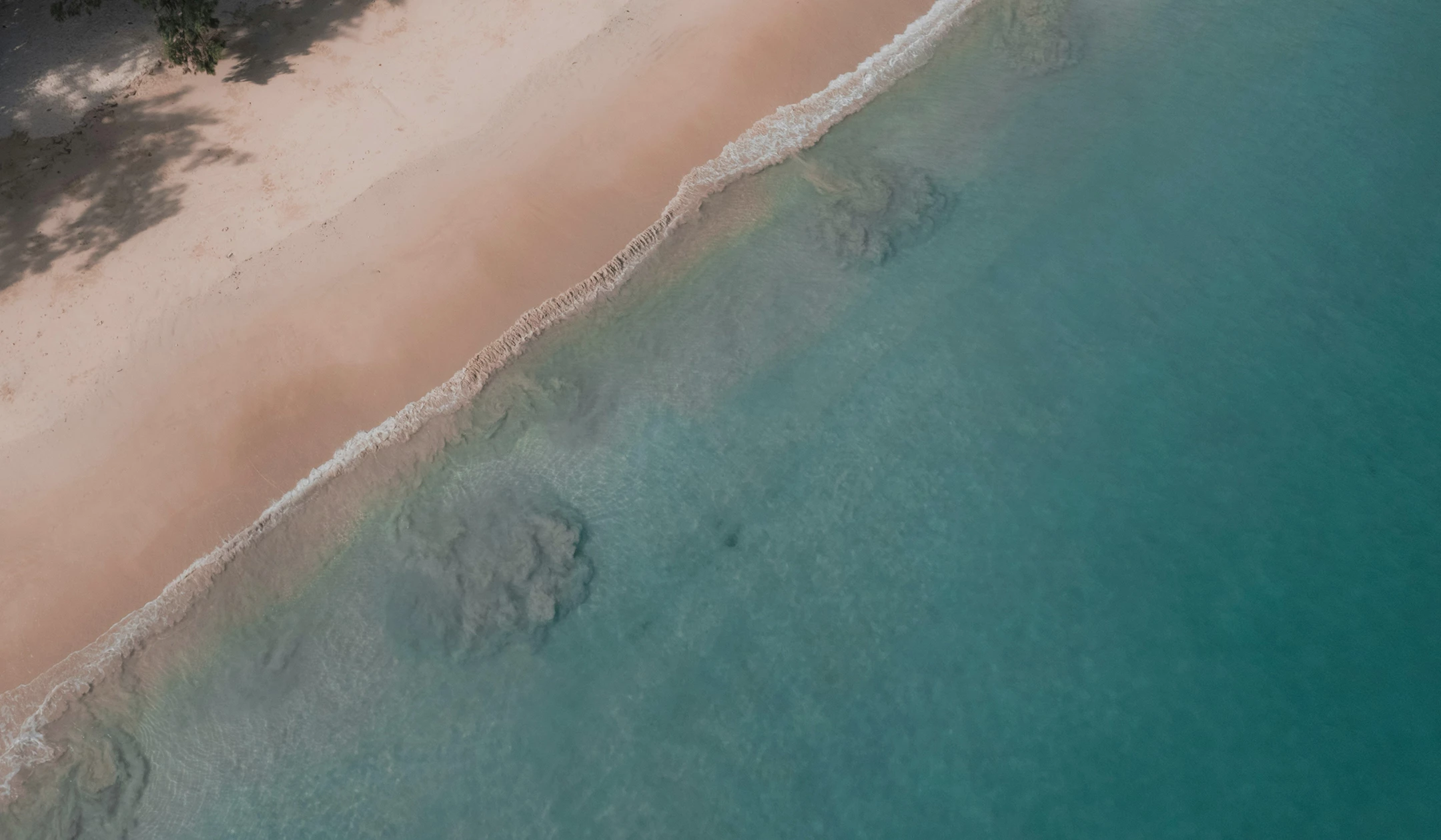 a beach with waves crashing on the shore