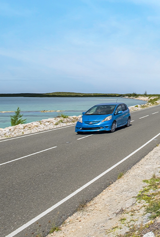 a blue car on a road