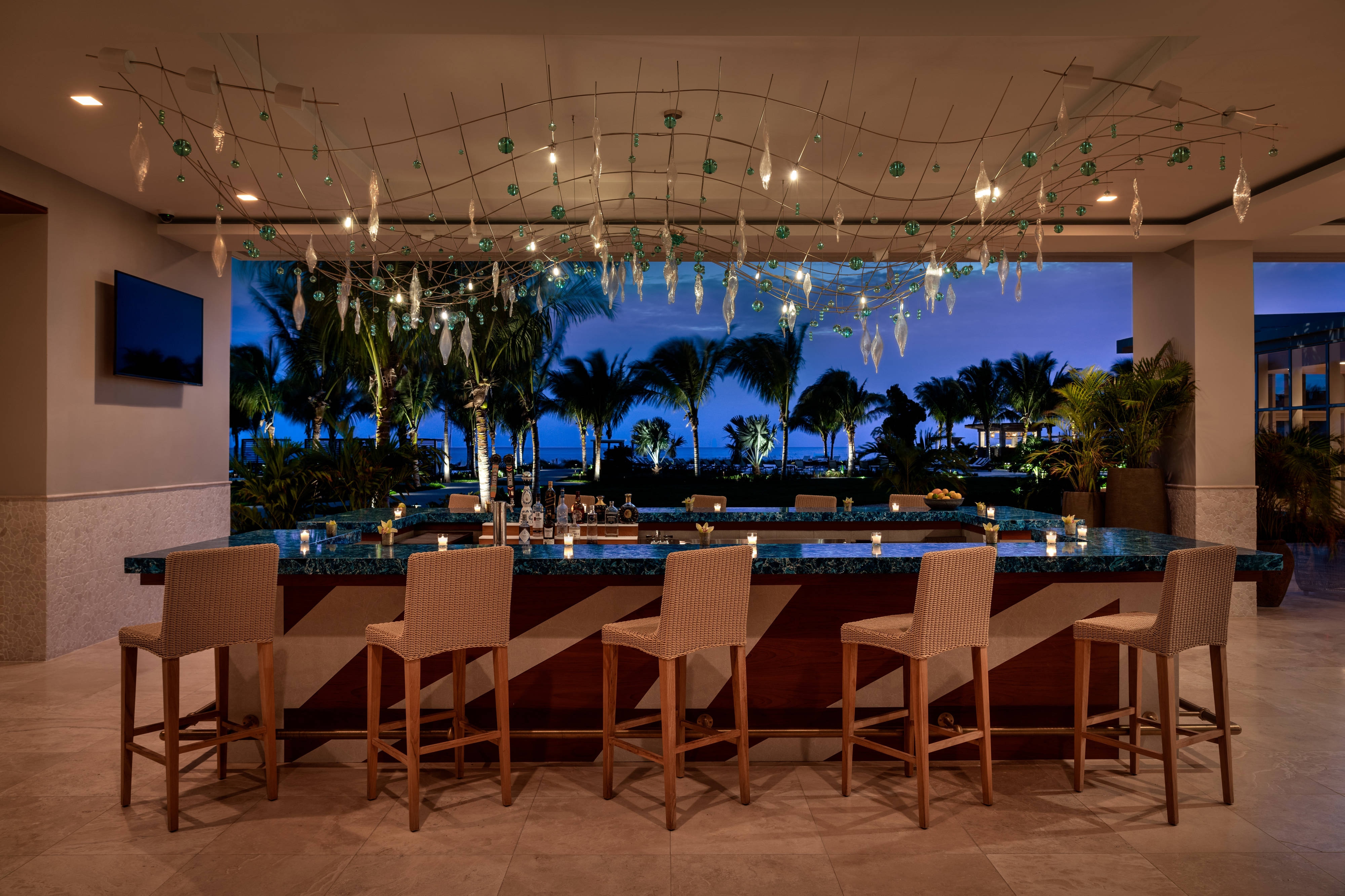 a bar with chairs and lights