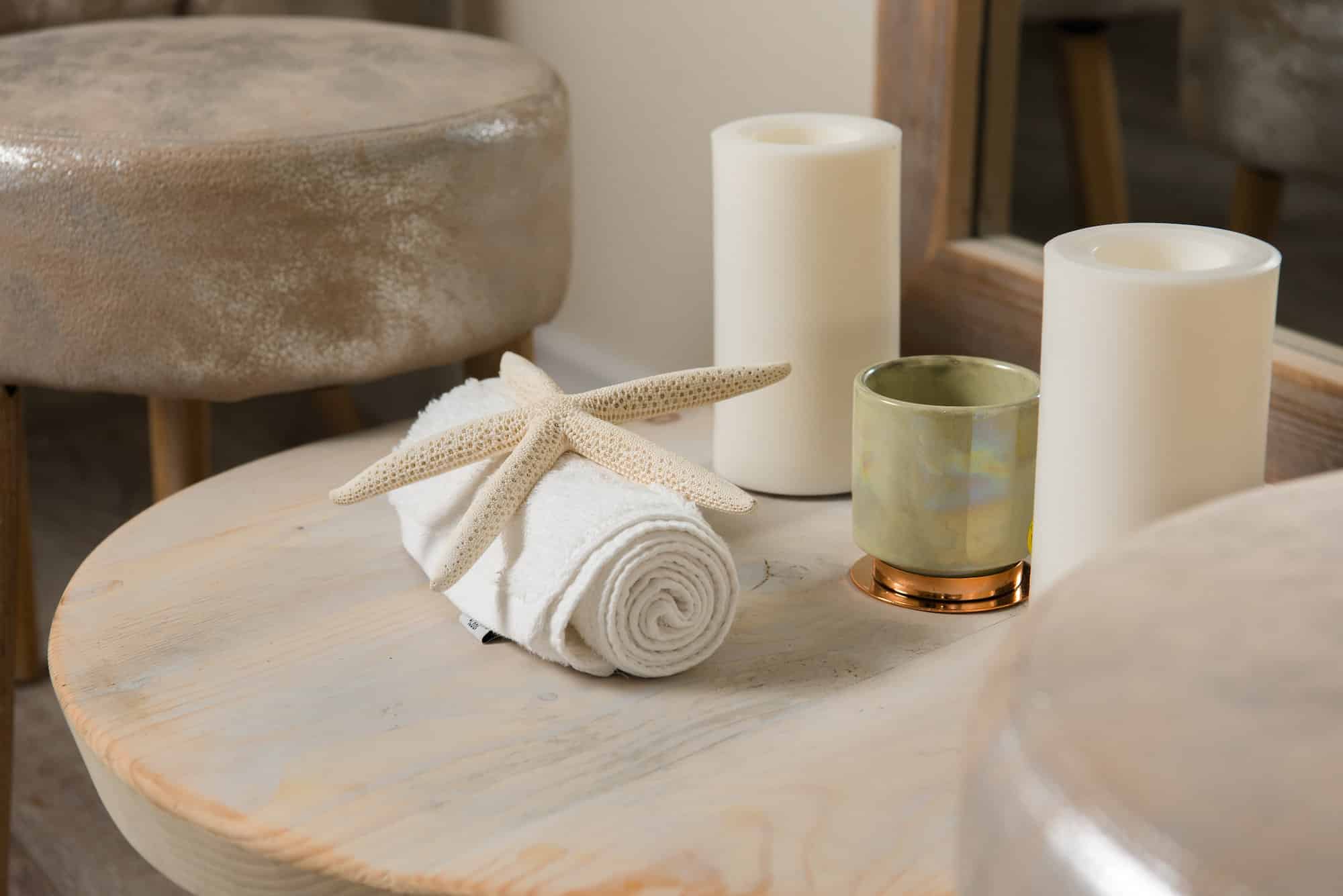 a starfish wrapped in towel and candles
