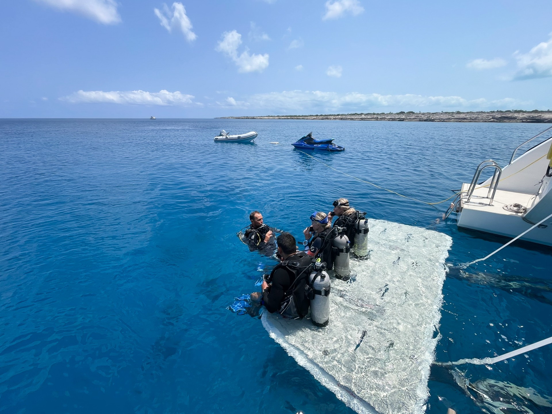 a group of people on a floating platform in the water