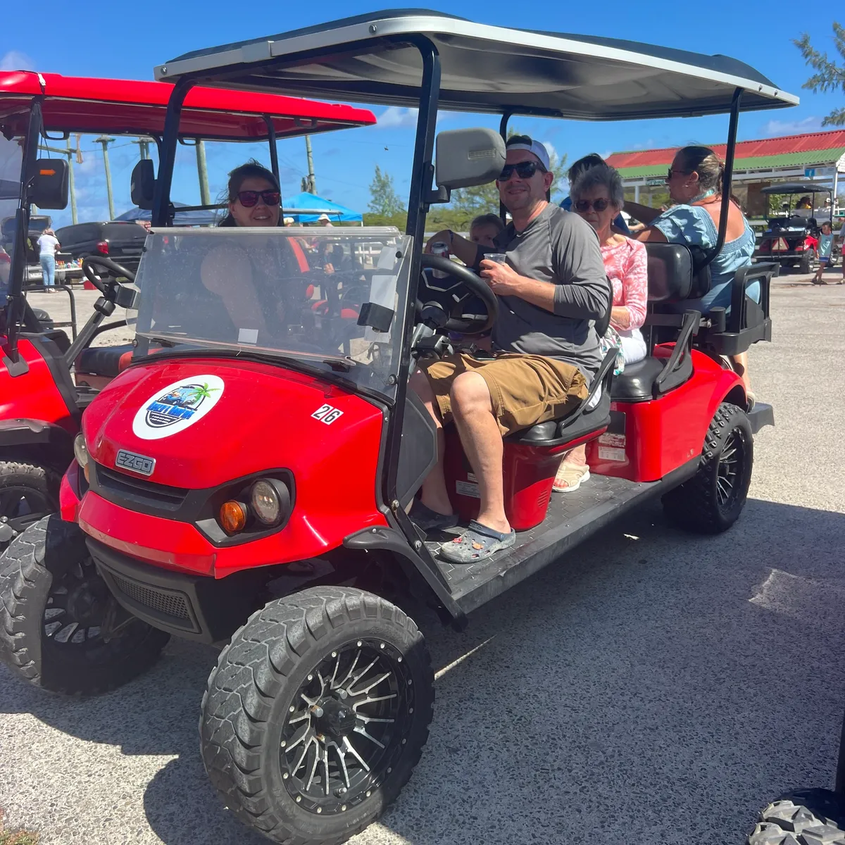 a group of people in a golf cart