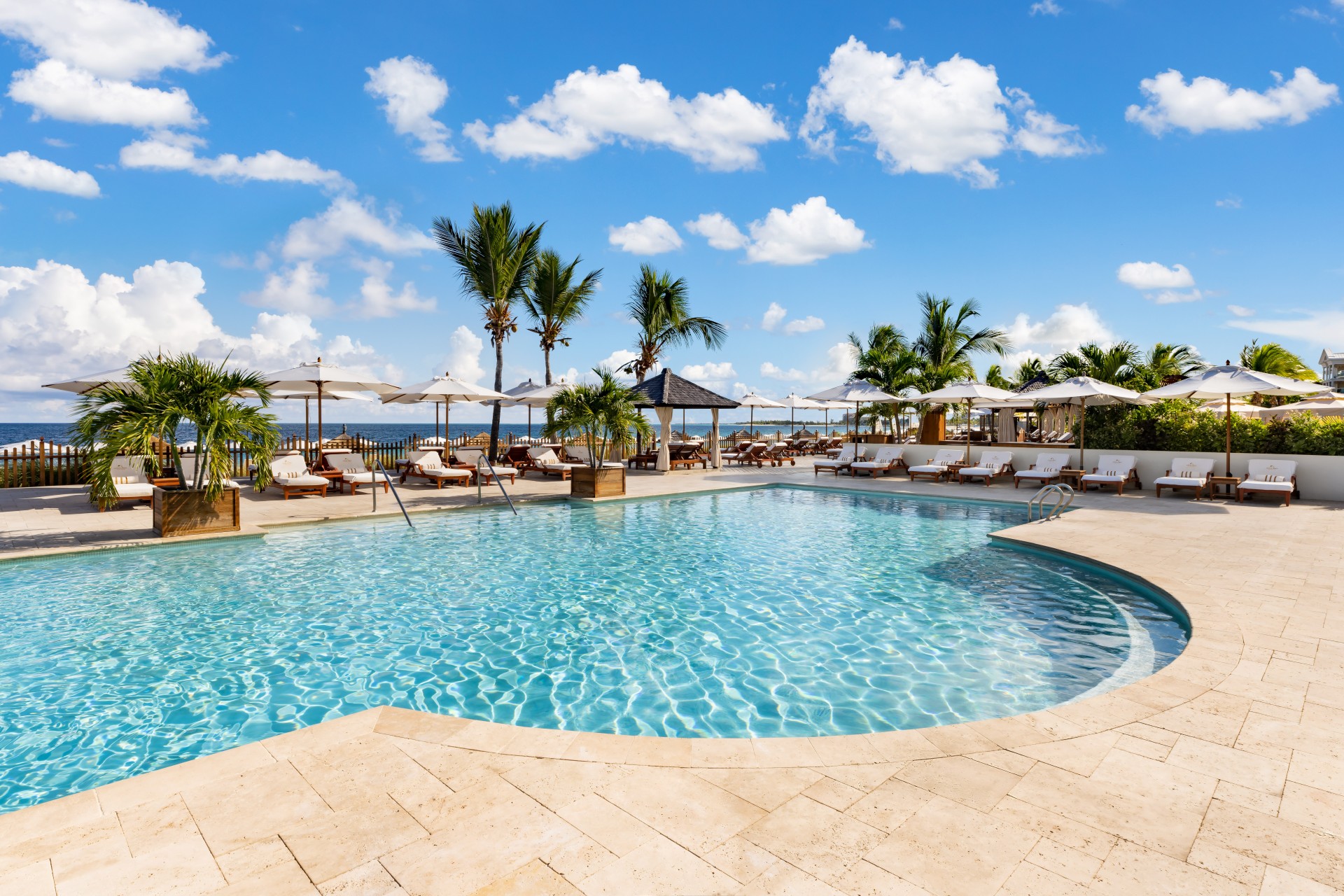 a pool with umbrellas and chairs