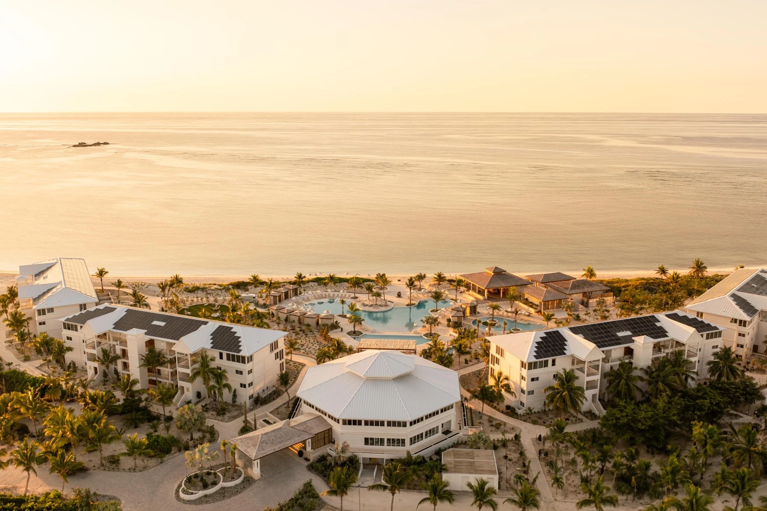a group of buildings next to a beach