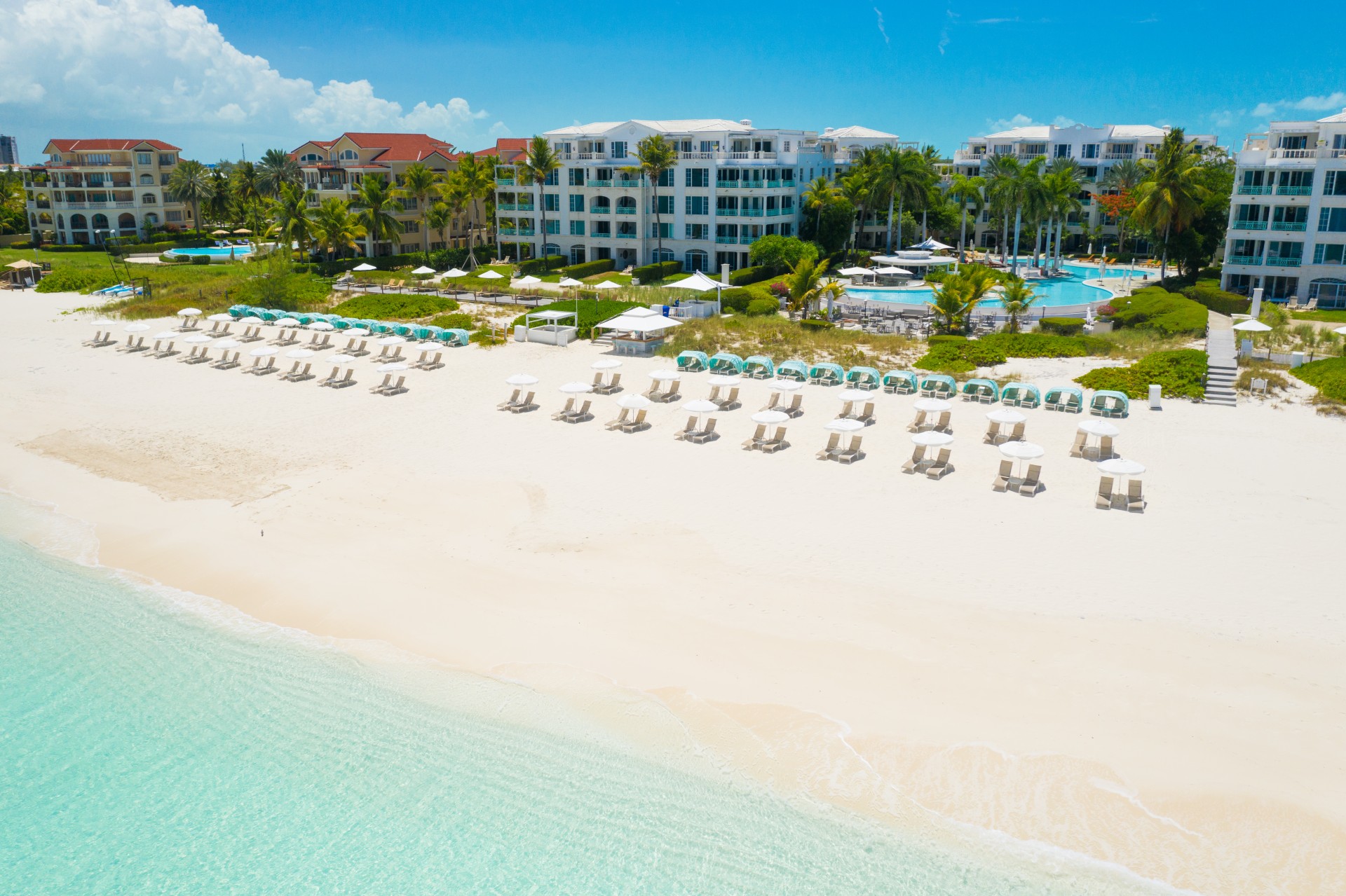 a beach with chairs and umbrellas