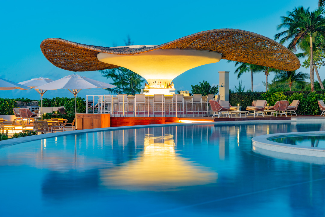 a pool with a bar and chairs