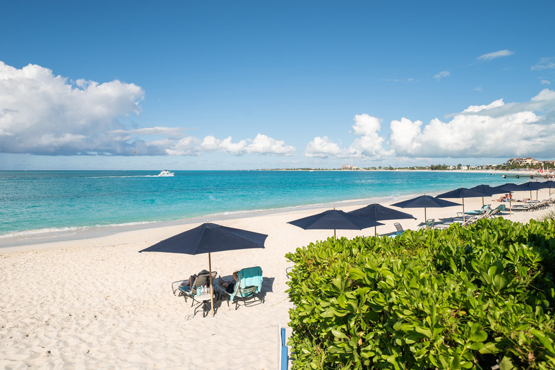 a beach with chairs and umbrellas
