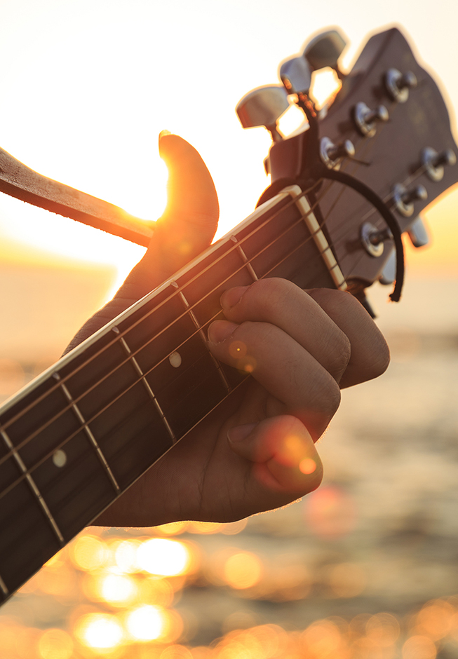 a hand playing a guitar