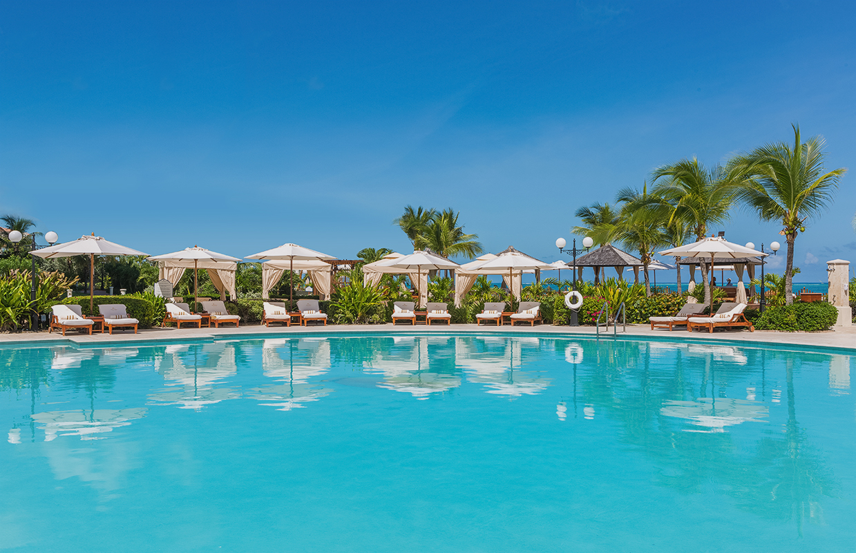 a pool with umbrellas and chairs