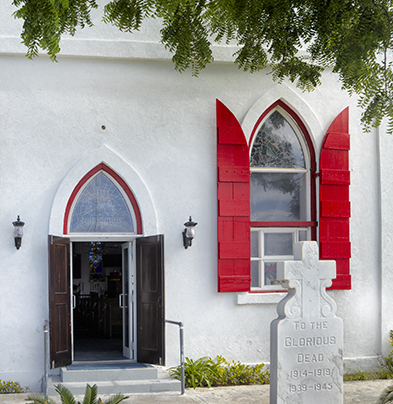 a white building with red shutters