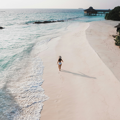 a woman walking on a beach