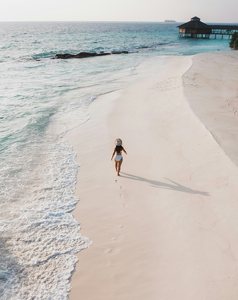 a woman walking on a beach