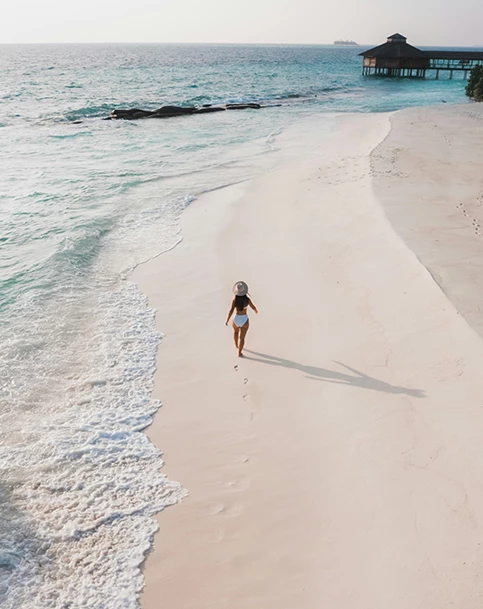 a woman walking on a beach