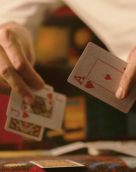 a person holding playing cards