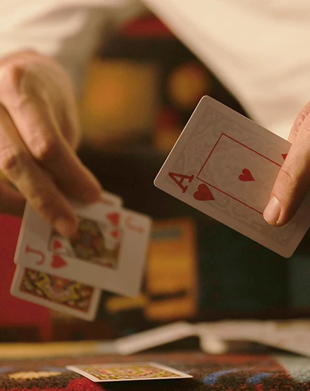 a person holding playing cards