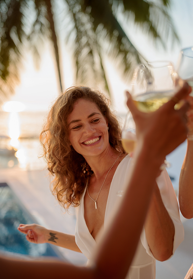 a woman holding wine glasses