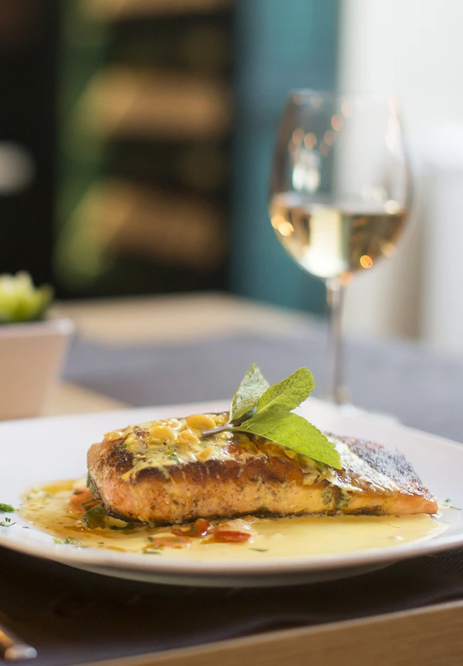 a plate of food with a glass of wine