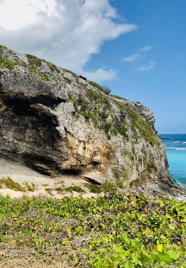 a rock cliff with a hole in the side