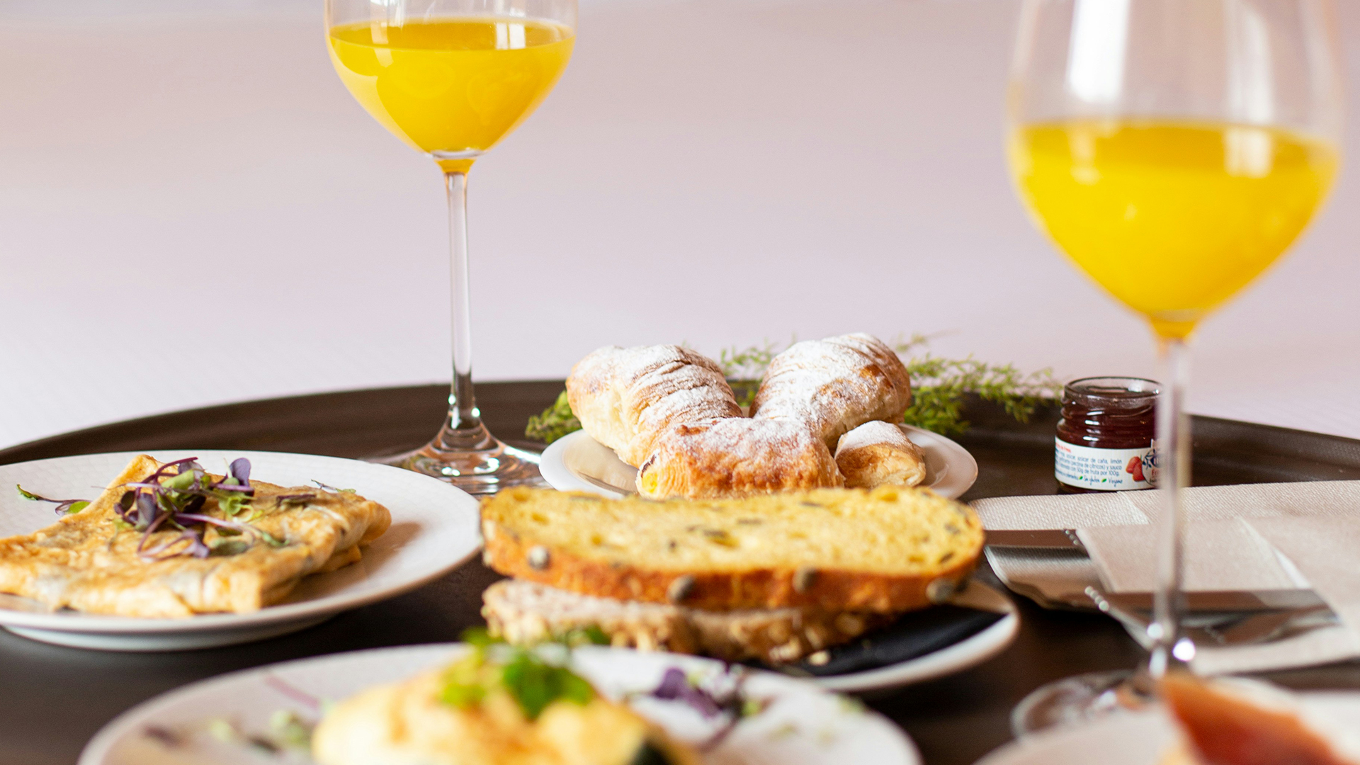 a plate of food and a glass of orange juice