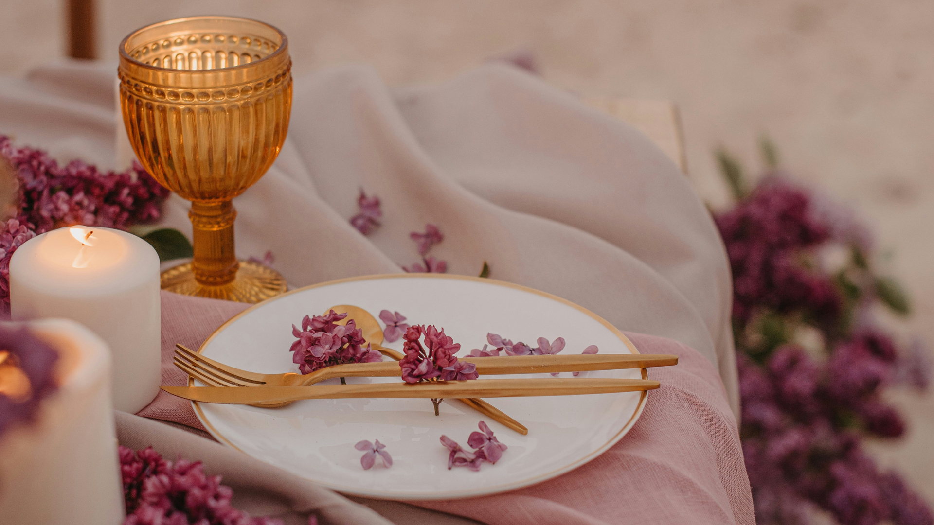 a plate with a fork and chopsticks on it and a glass with purple flowers