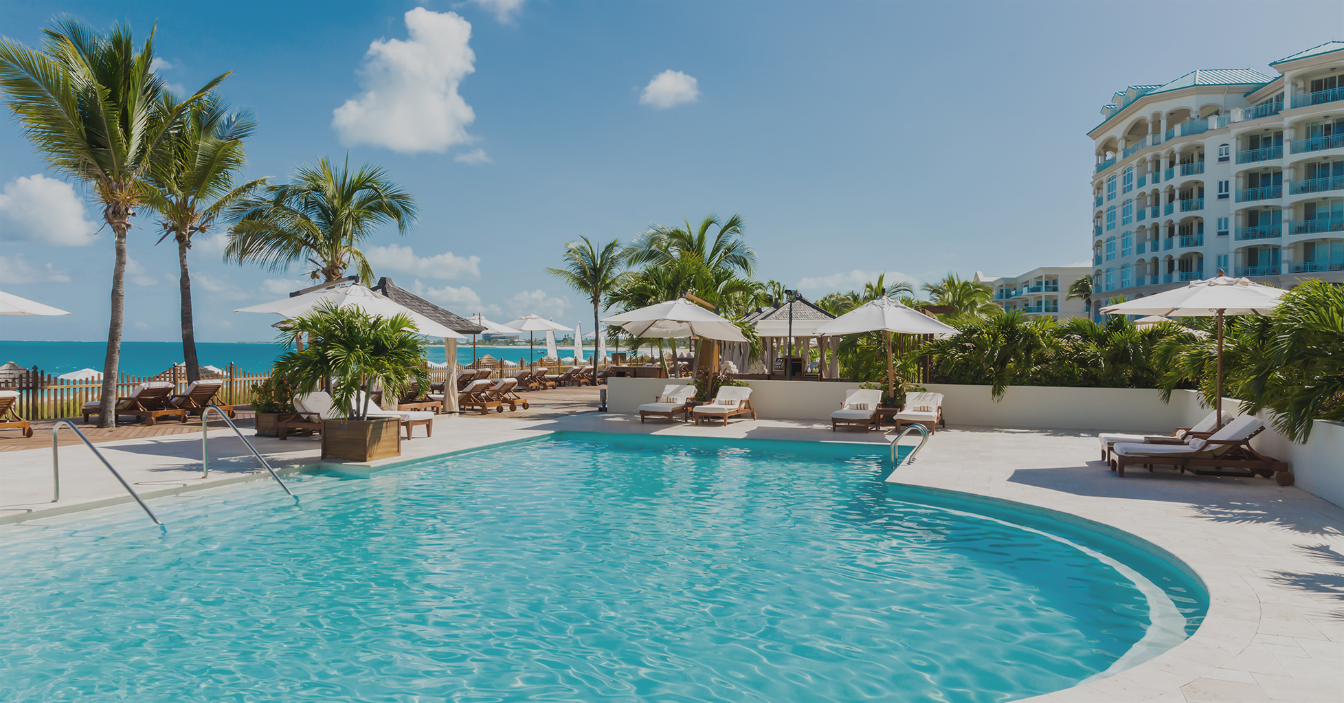 a pool with umbrellas and chairs