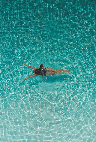 a woman swimming in a pool