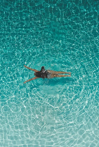 a woman swimming in a pool