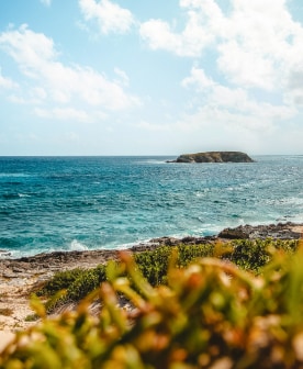 a body of water with a small island in the distance