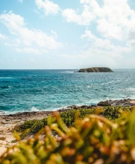 a body of water with a small island in the distance