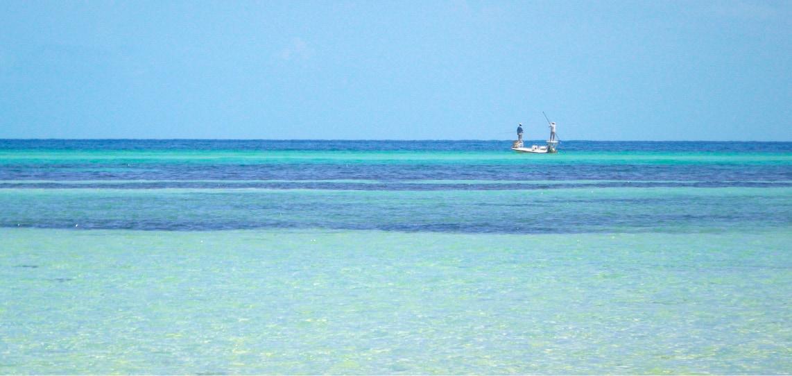 a man fishing in a boat in the ocean