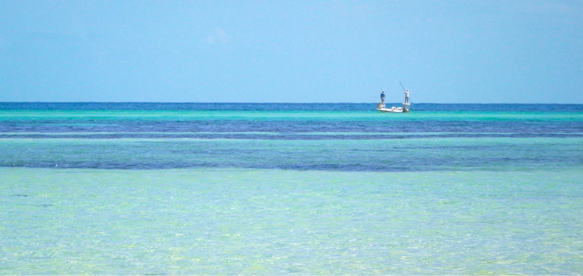 a man fishing in a boat in the ocean