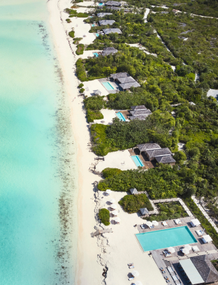 a beach with houses and pools