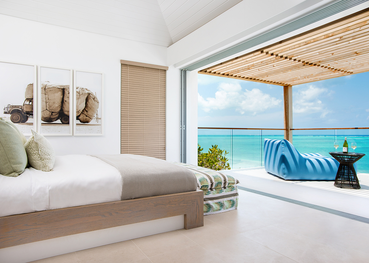 a bedroom with a large glass door and a large bed