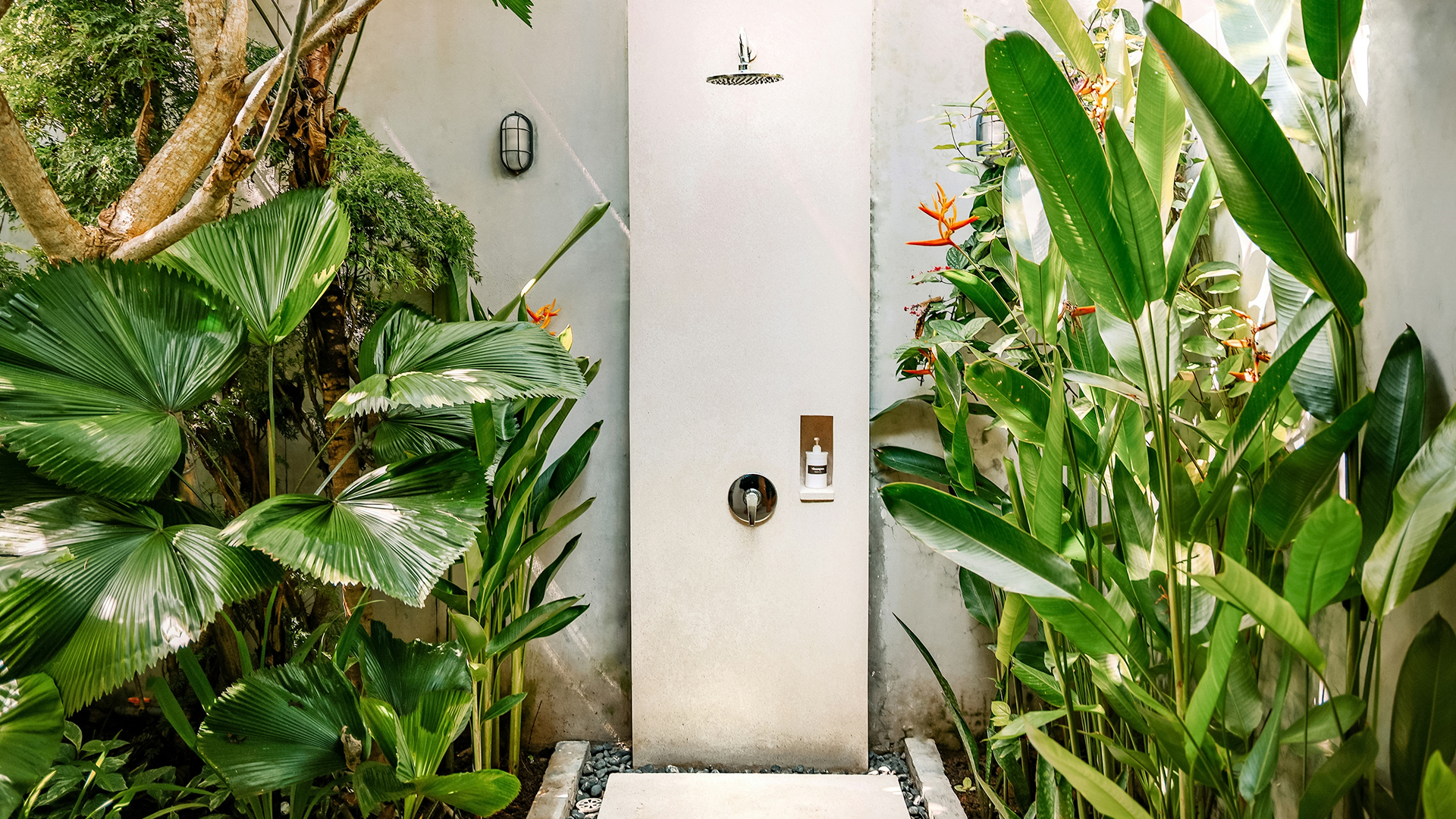 a white door with a water tap in a garden