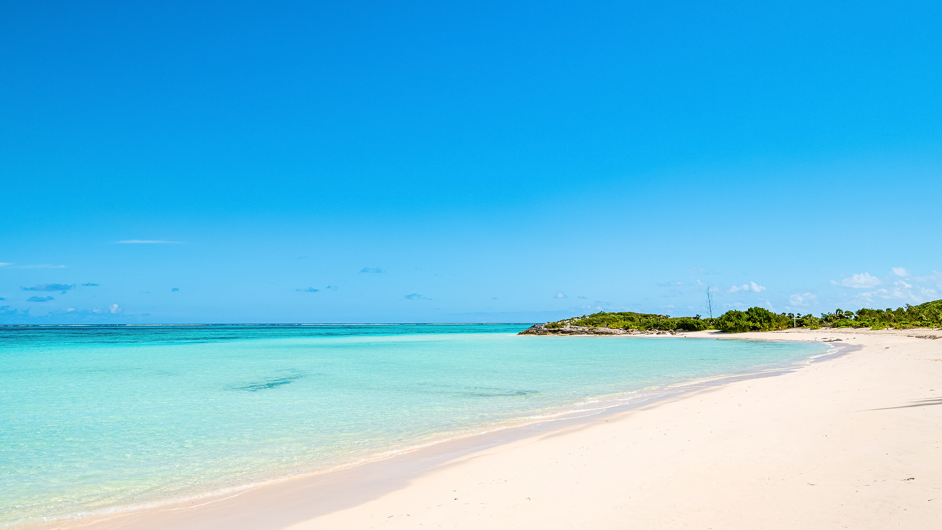 a beach with a small island in the background
