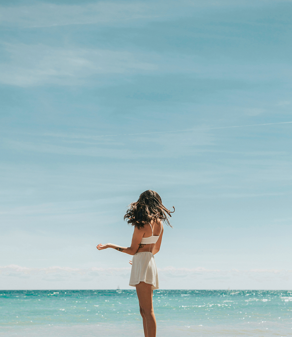 a woman standing on a beach