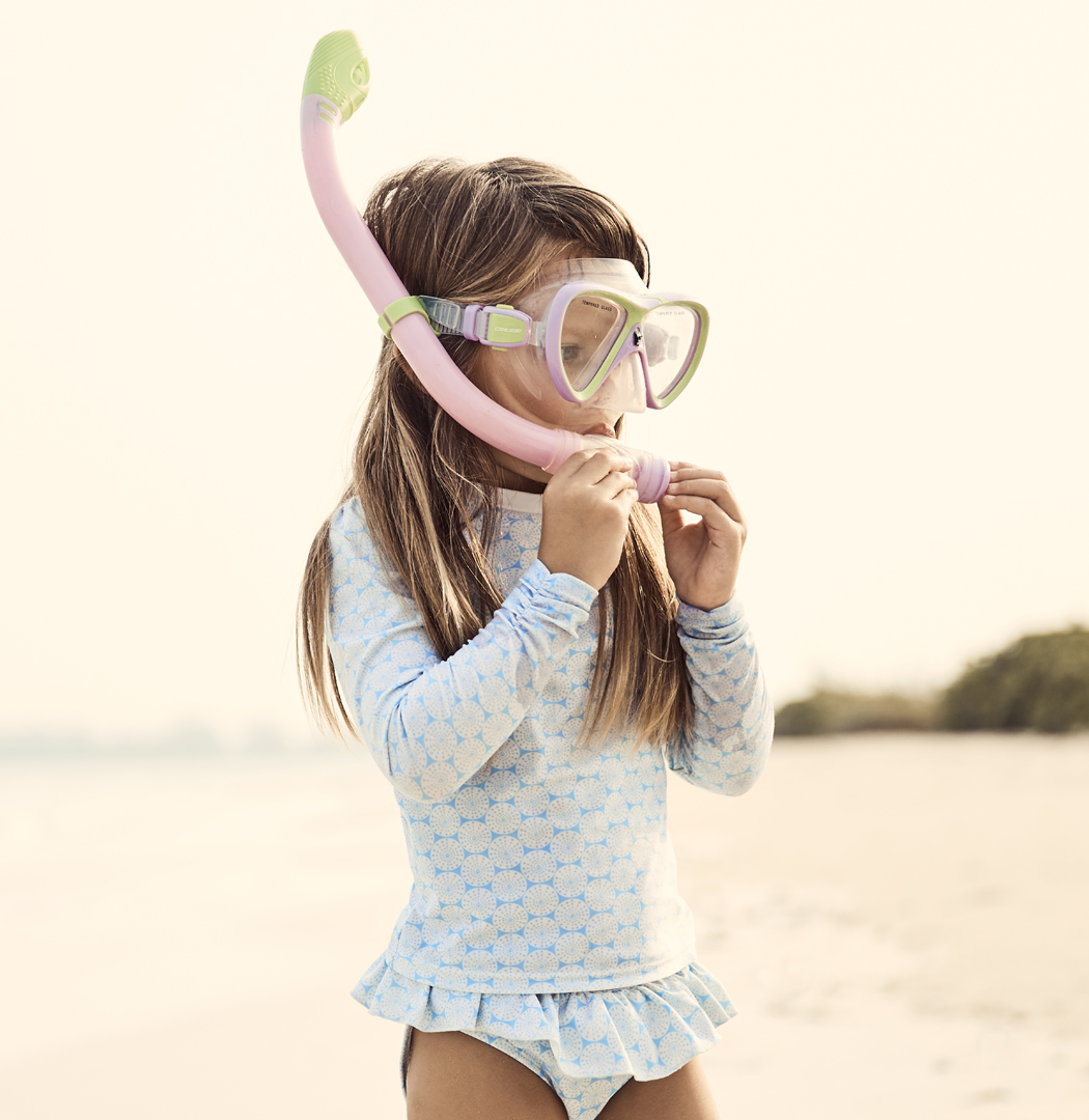 a girl wearing a swimsuit and snorkel