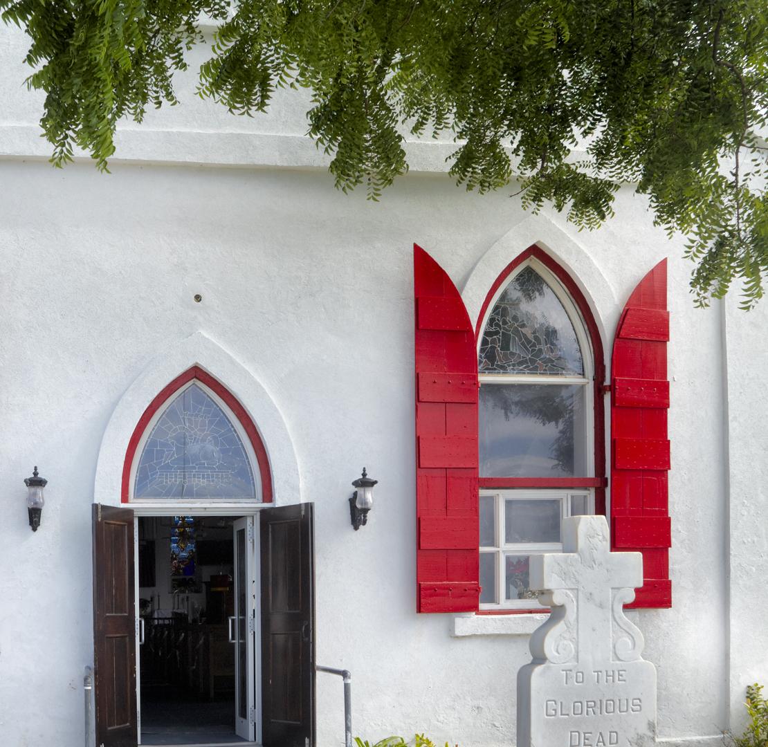 a white building with red shutters
