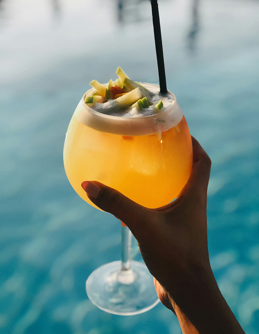 a hand holding a drink
