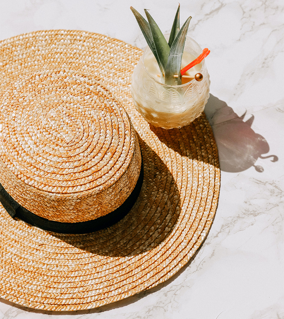 a straw hat and a drink