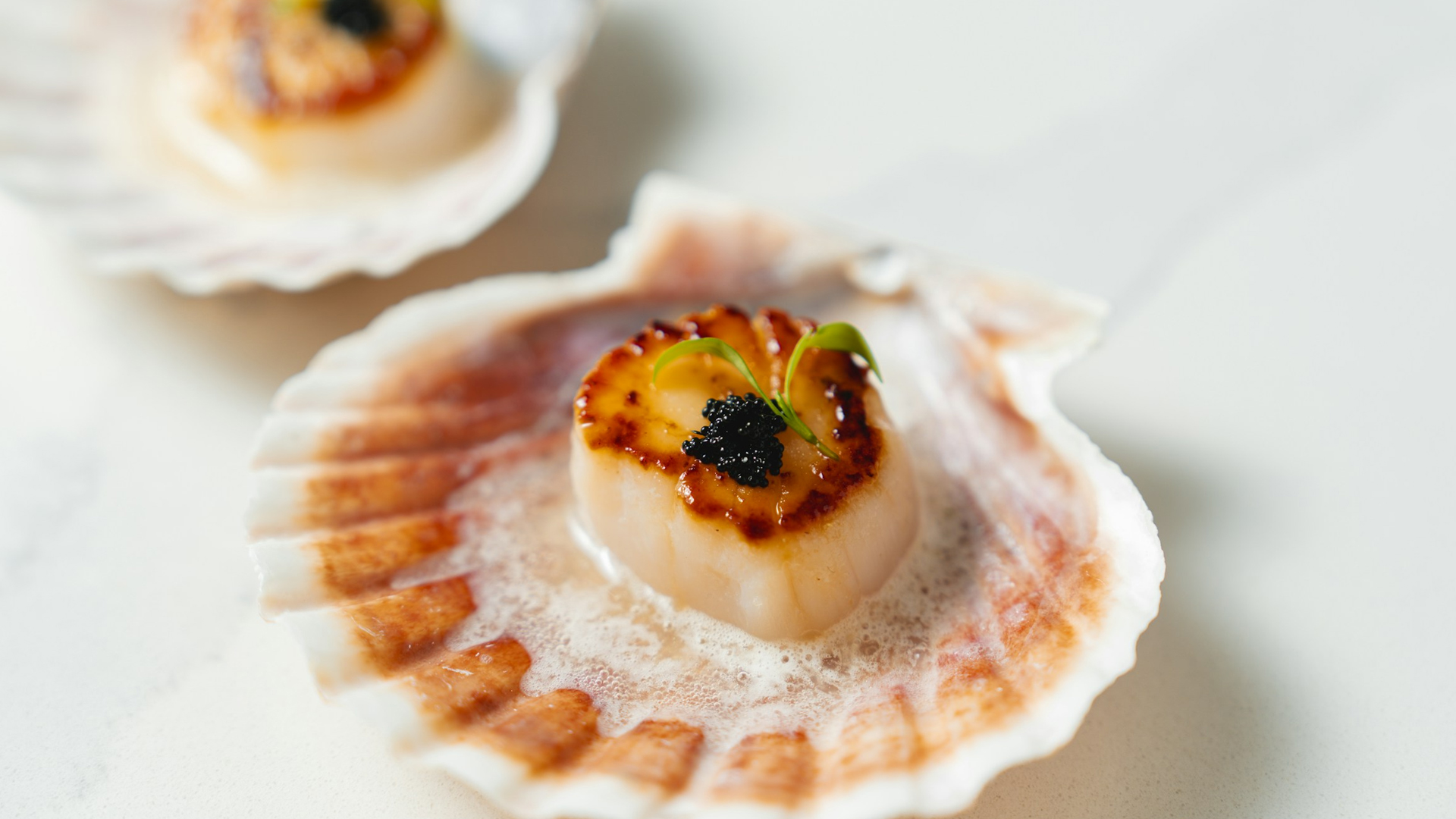 a scallop with a black caviar on top